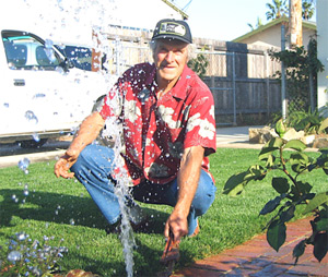 a technician is fixing a broken sprinkler head